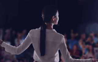 Conference speaker giving a talk in front of an audience