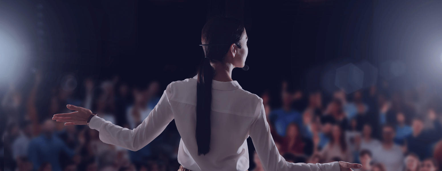 Conference speaker giving a talk in front of an audience