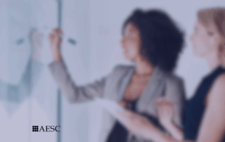 Two professionals strategizing at the whiteboard