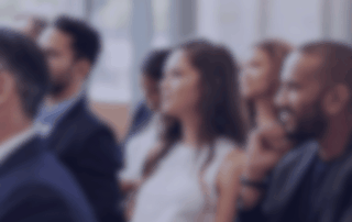 Professionals listening to a conference session